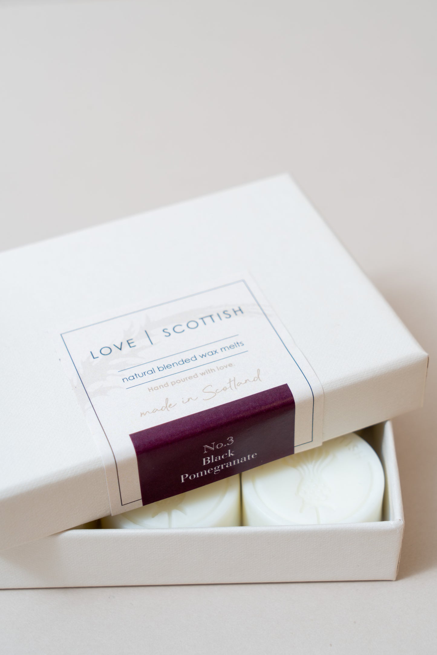 Black Pomegranate Wax Melts on a white Background