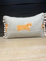 Tuppence-Orange Highland Coo long cushion with pompom trim