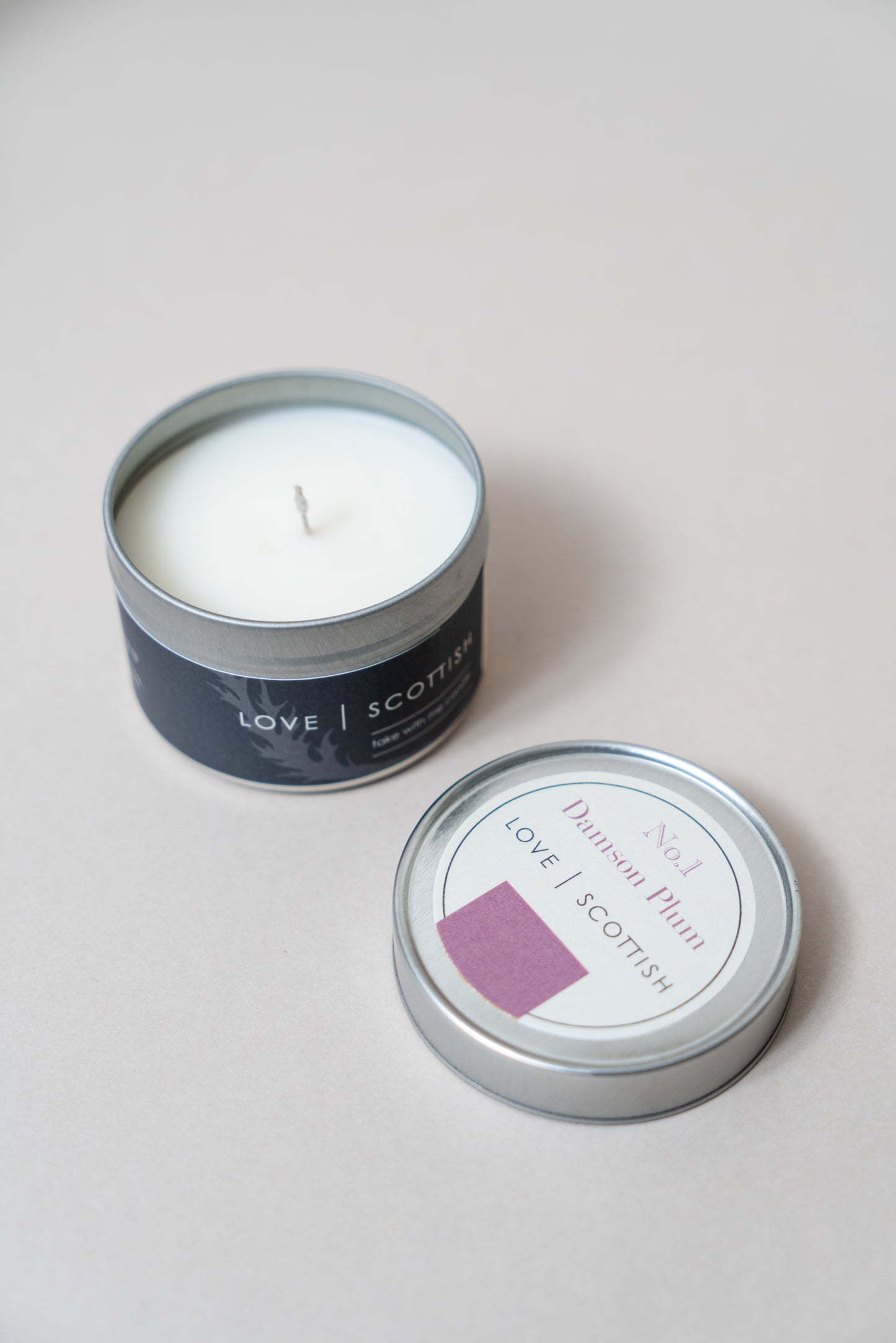 Damson Plum Travel Tin Candle on a White Background
