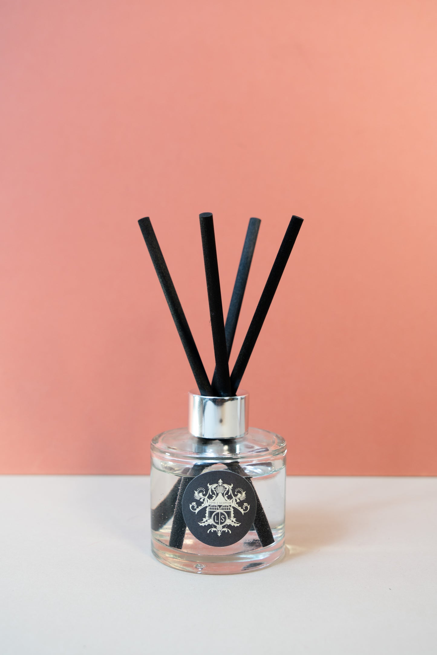Black Pomegranate Diffuser on a Pink Background