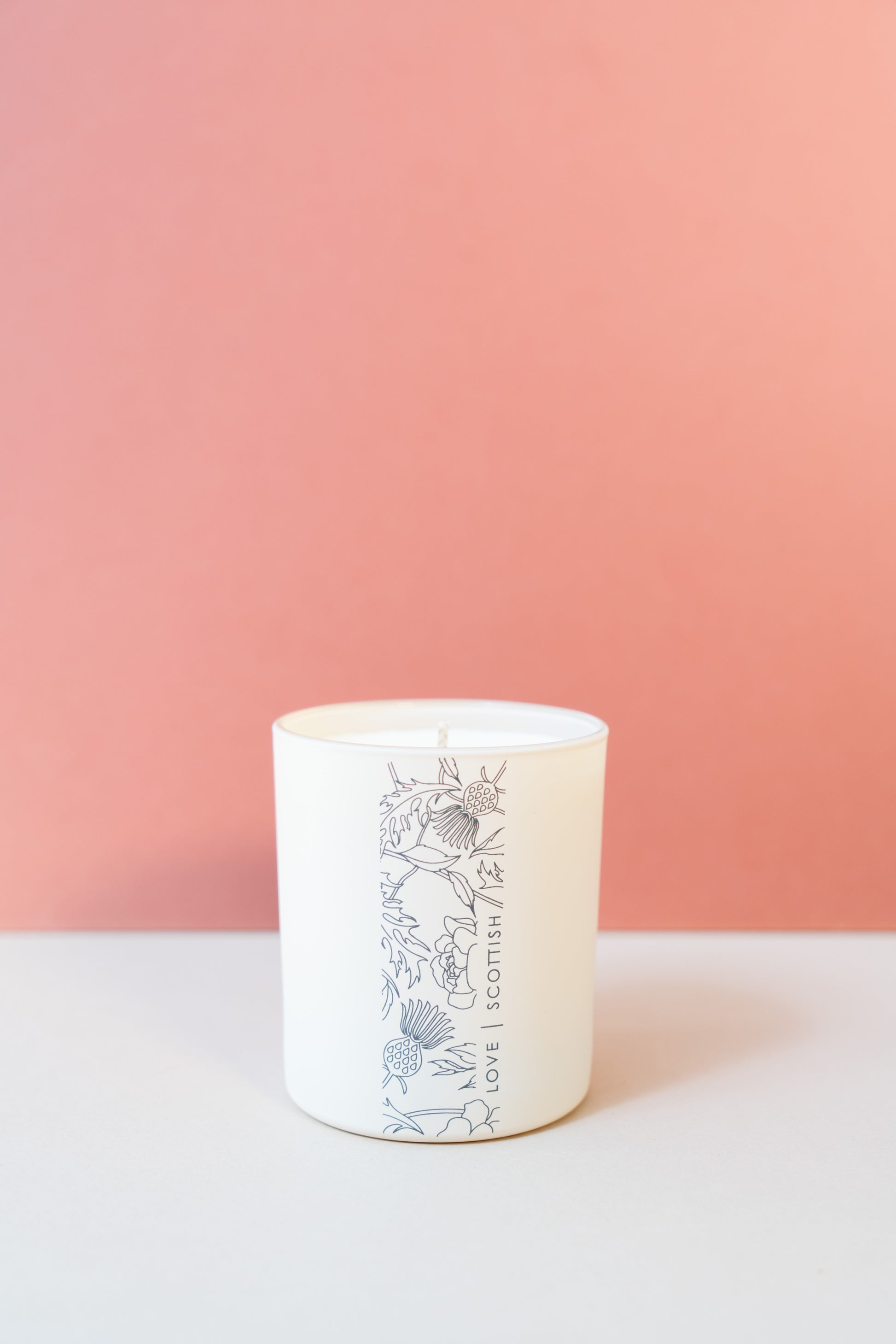 Medium Candle on a Pink and White Background